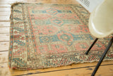 Geometric Avar rug design with softened rose, pale blue-green tones and stylized animal motifs.