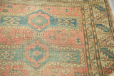 Antique Avar rug with softened rose and pale blue geometric motifs.