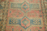 Softened rose and pale blue geometric Avar rug detail with stylized animal interpretations.