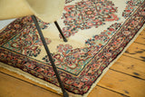 Intricate floral sprays on vintage Sarouk rug with ivory to antique ivory field.