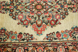 Fine weave of vintage Sarouk rug with tropical floral sprays and decorative border.