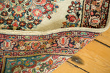 Hand-knotted vintage Sarouk rug, close-up of fine floral pile and vibrant woven border.