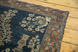Antique Farahan Sarouk rug with intricate burnt brick border and navy blue field.