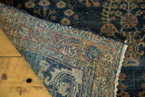 Antique Sarouk rug's fine hand-knotted foundation in blues, burnt brick, and beige.