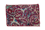 Antique Kerman fragment mat with allover curvilinear floral design in ruby red, cream, and blue.