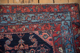 Intricate Herati design within the sky blue and madder red borders of a vintage Engelas rug.