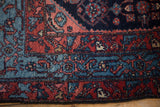 Vintage Engelas rug corner showing the sky blue main border and intricate Herati design.