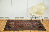 Ruby purple field with allover herati design and brilliant blue border of a Lilihan rug.