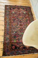 Vintage Lilihan rug with ruby purple herati pattern, brilliant blue border, and fringe.