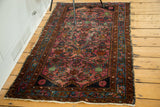Traditional Lilihan rug with allover herati design, ruby purple field, blue border.