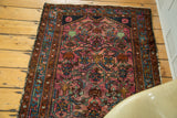Vintage Lilihan rug's ruby purple field with detailed Herati pattern and blue border.