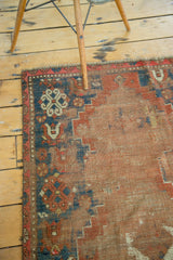 Antique Caucasian rug corner, distressed flat texture, tribal geometric patterns in rust and navy.