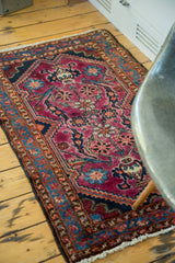 Vintage Lilihan rug corner: brilliant blue border, ruby purple field, tree-of-life motifs.