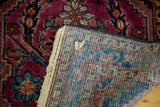 Vintage Lilihan rug's ruby purple floral pile and securely finished, multi-colored woven back.