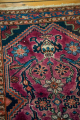 Close-up of vintage Lilihan rug field with ruby purple tone and mirrored planters.