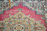 Intricate floral patterns, raspberry field, dark sand medallion, and slate blue spandrel.