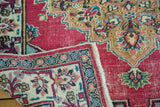 Visible raspberry field, ornate ivory border, and delicate floral motifs on the vintage Meshed rug.