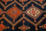 Vintage Northwest Persian rug's rectilinear serrated medallions, indigo, orange, cream, and abrash.