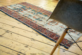 Distressed ivory field and patterned geometric border of an early 20th century Lilihan runner.