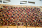 Unique repeating gul pattern and recessed pile on an antique Turkmen Chuval rug.