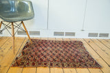 Antique Turkmen square rug with unusual repeating guls, showing overall aged pile.