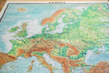 Vintage Europe pull-down map displaying detailed physical geography and blue seas.