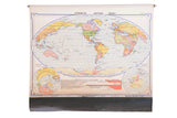 Vintage 1930s Modern World pull-down map with colorful continents and oceans.
