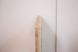Side edge of the vintage 1950 painting, showing stapled canvas texture.