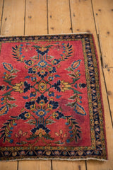 Close-up of deeply saturated cherry red vintage Mohajeran Sarouk rug, mirrored laurel wreath motif.
