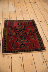 Mohajeran Sarouk rug's lower corner, highlighting dark blue border and cherry red floral pattern.