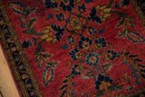 Vintage Mohajeran Sarouk rug with deeply saturated cherry red field and floral laurel wreath motif.