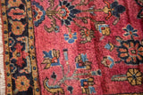 Traditional vintage Mohajeran Sarouk rug detail: maroon floral patterns, bordered edge, and white fringe.