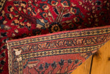 Vintage German Sarouk rug, showing secured edge and hand-knotted foundation weave.