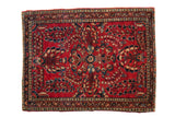 Vintage Sarouk rug, deeply saturated cherry red, dense floral sprays and borders, mid-20th century.