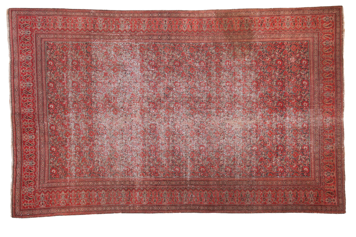 Distressed antique Doroksh rug with an allover vine and leaf pattern in smokey red and charcoal bronze.
