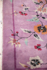 Vintage Art Deco rug detail: mauve purple field, thin border, orange and red floral vines.