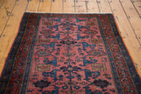 Vintage Lilihan rug close-up: intricate blue and dusty rose Gerrus design, secured side.