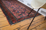 Vintage Lilihan rug corner with dusty rose field, blue Gerrus design, and fringe.