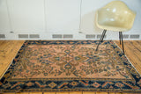 Stylized turtle samovar border and rosy pink herati motif on this antique Lilihan rug.