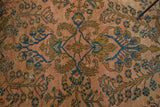 Antique Lilihan rug's central stylized Herati motif in rosy pink, gold, and navy blue.