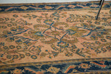 Antique Lilihan rug close-up: rosy pink field, detailed Herati motif, stylized navy border.