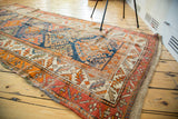 Distressed antique Caucasian runner: funky geometric medallions in blue, orange, red, and ivory.