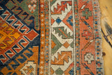 Aged edge and colorful geometric patterns on the antique Caucasian runner.