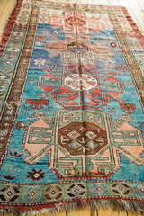 Geometric patterns, vibrant abrashes, and visible wear on antique Southern Caucasian rug.