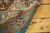 Antique Southern Caucasian rug detail: unique geometric border, abrashes, and visible areas of wear.