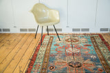 Antique Southern Caucasian rug, unique outer border, geometric patterns, abrashes in blue, teal, coral.