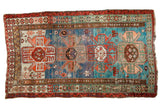 Antique Southern Caucasian rug with abrash blues, teal, and bold geometric medallions, 4'9