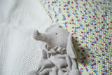 Close-up of the gray organic Egyptian cotton baby elephant, featuring soft terry texture and striped ruffle.