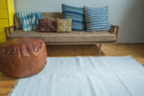 Soft, handmade organic cotton white rag rug with simple woven texture and fringe, 4x6.