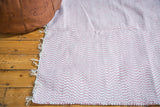Soft pink and white organic cotton rag rug, subtle chevron weave.